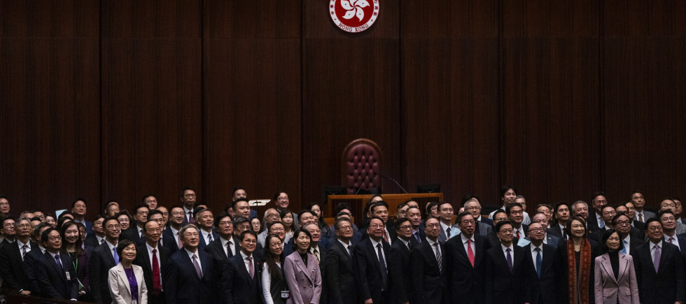 Hong Kong's Chief Executive John Lee, fifth foreground left, pose for photographs with lawmakers following the passing of the Basic Law Article 23 legislation at the Legislative Council in Hong Kong, Tuesday, March 19, 2024. 