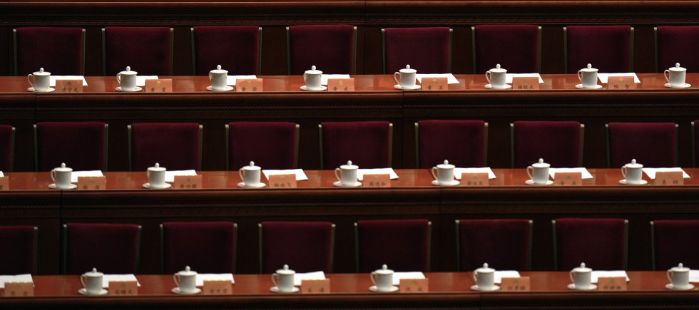 A hostess aligns the paperworks for members of the National Committee of the Chinese People's Political Consultative Conference (CPPCC) ahead of the closing session of the CPPCC at the Great Hall of the People in Beijing, Sunday, March 10, 2024. 